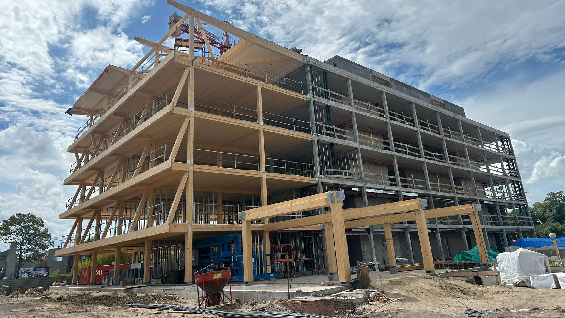 Hybrid timber and concrete building under construction in Uruguay with exposed structural frame