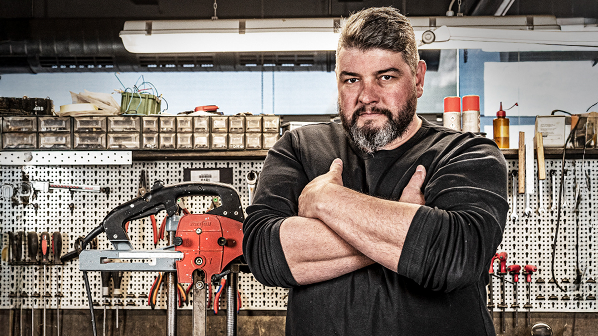 Technician specialized in woodworking machines standing in a workshop with professional carpentry tools and timber processing equipment. 