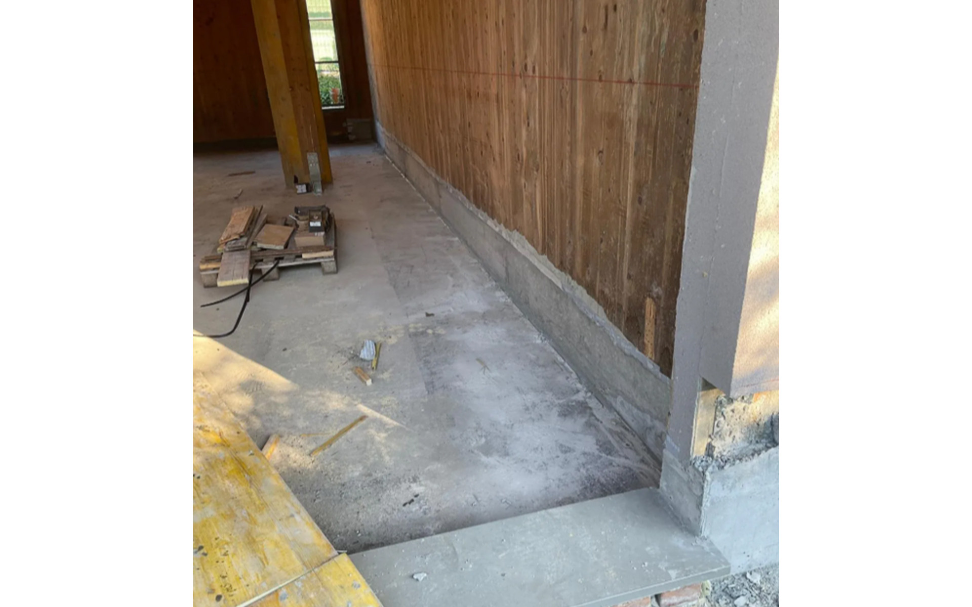 Completed timber building retrofit with restored X-LAM base connection and concrete foundation upgrade
